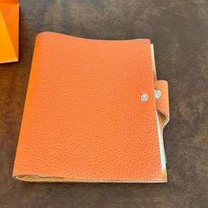 Hermes Ulysse Orange PM notebook.